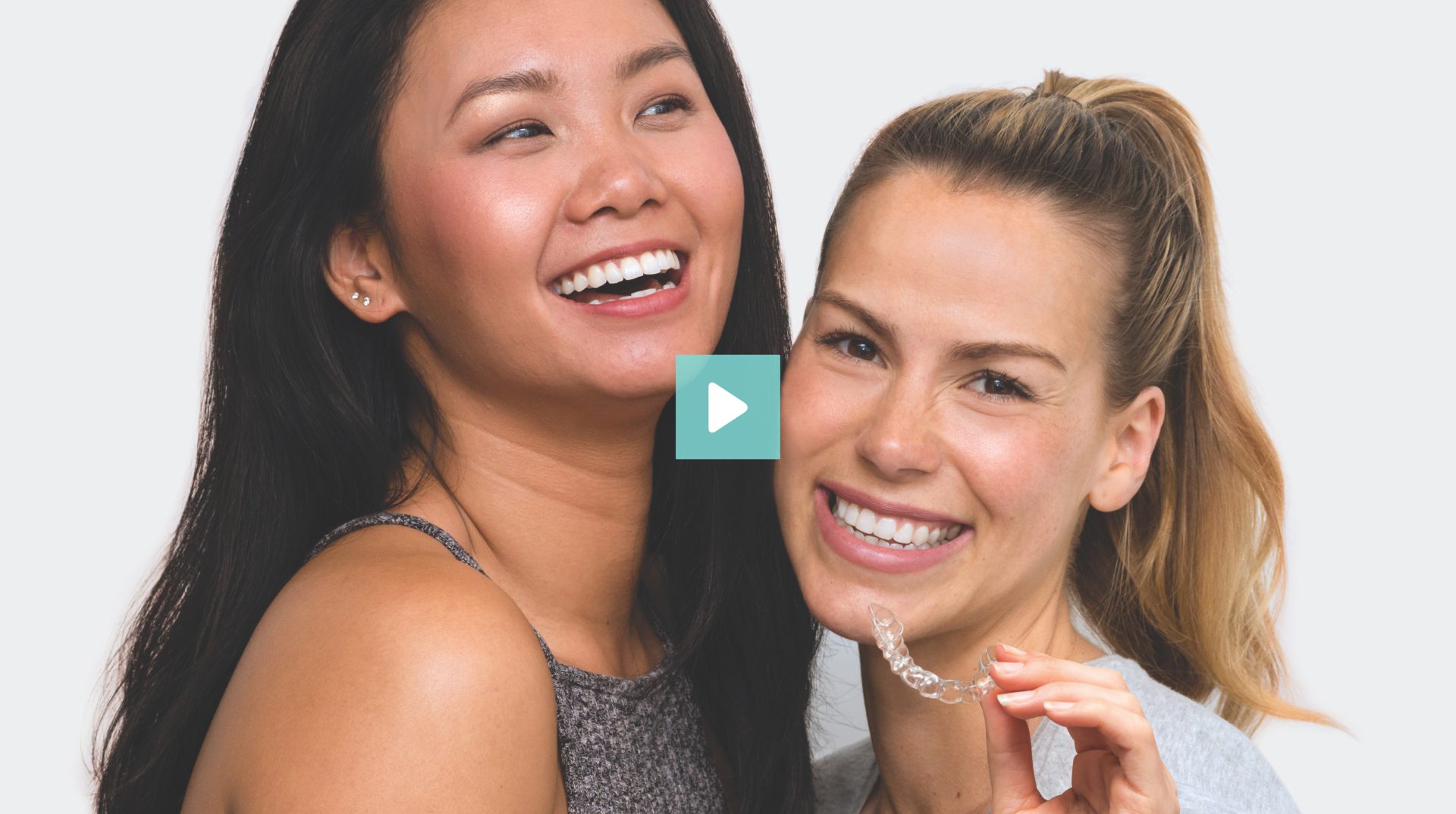 2 girls holding EZ SMILE aligner